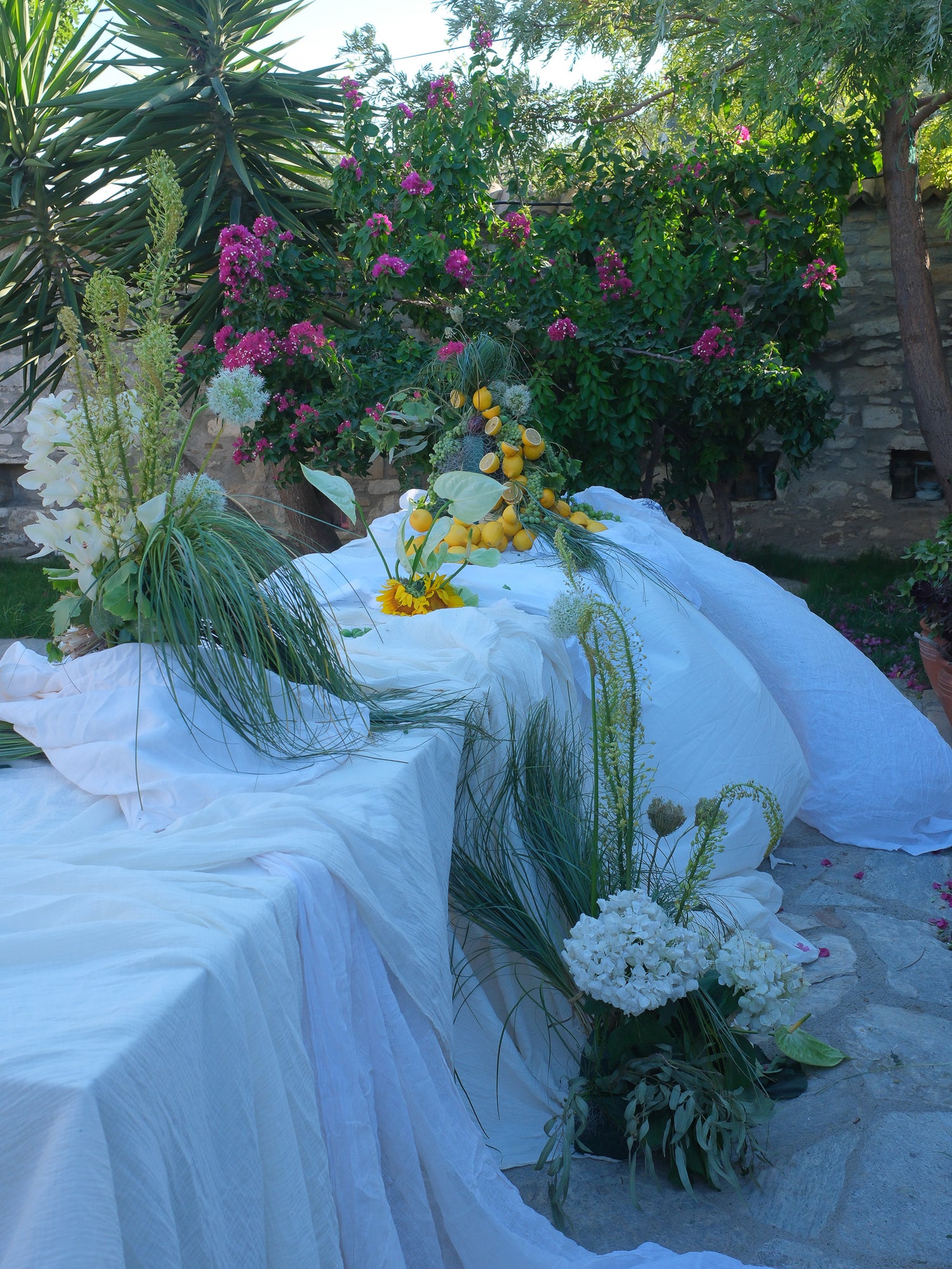 Decorative table setup with flowers and white tablecloth in an outdoor setting